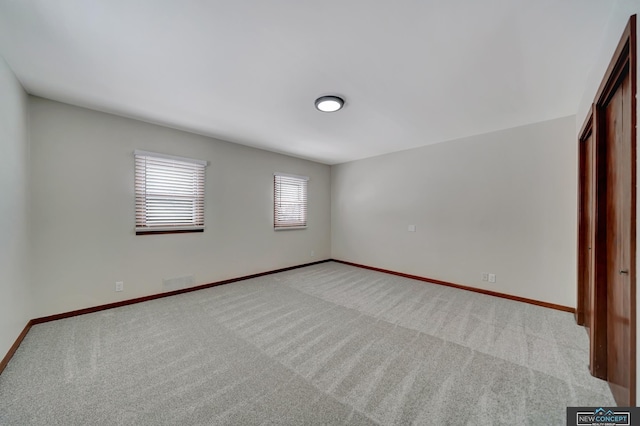 spare room with light colored carpet