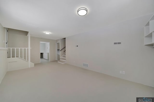 unfurnished room with light colored carpet