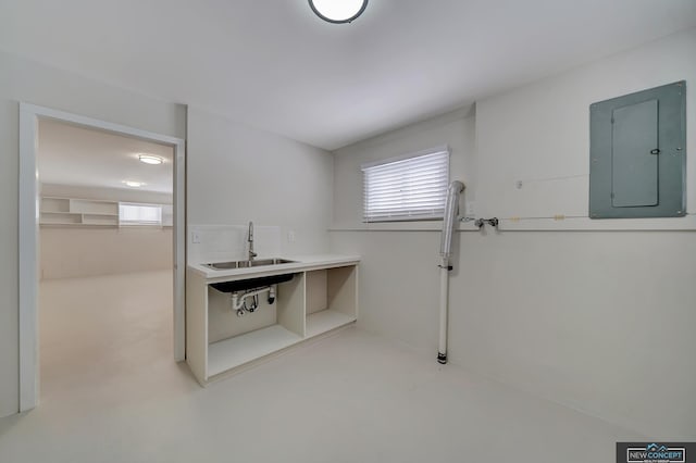 laundry area with electric panel, plenty of natural light, and sink