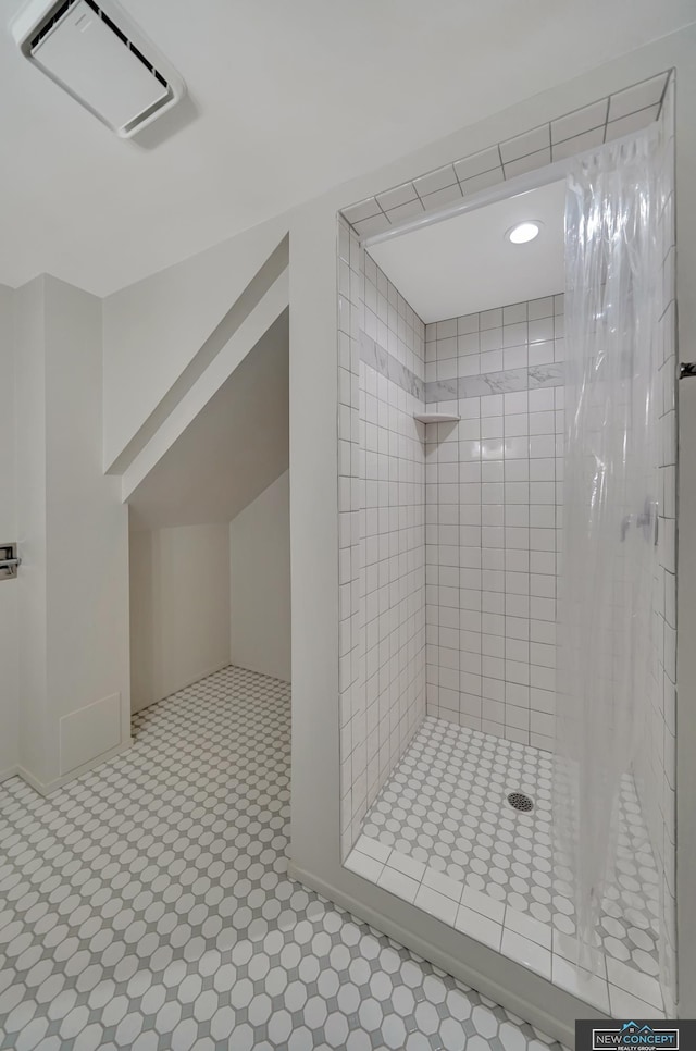 bathroom with a tile shower