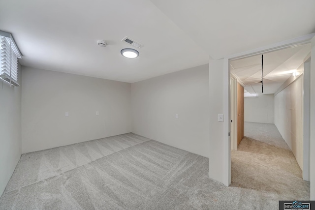 basement featuring light colored carpet