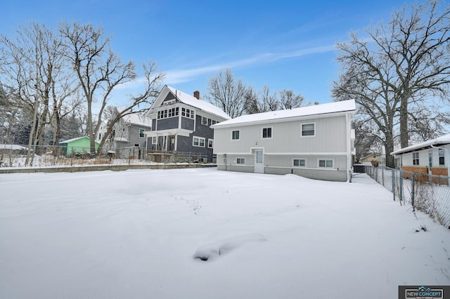 view of snow covered back of property