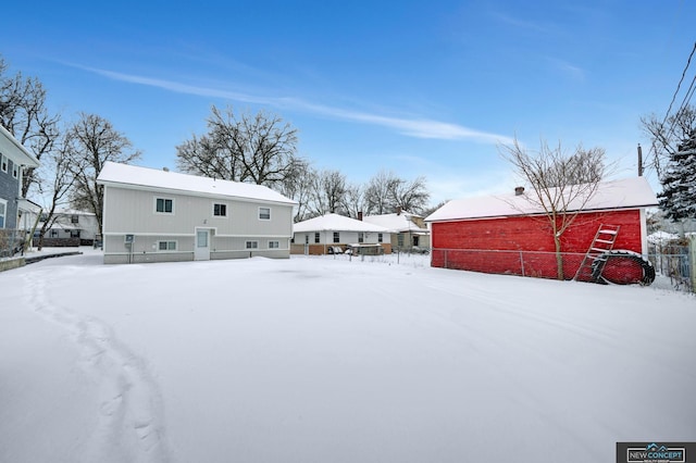 view of snow covered rear of property