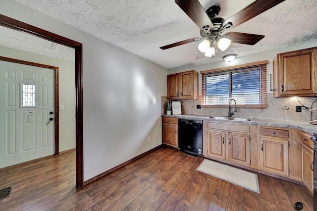 kitchen with a sink, black dishwasher, light countertops, decorative backsplash, and dark wood-style floors