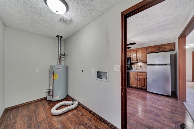 utility room featuring gas water heater and visible vents