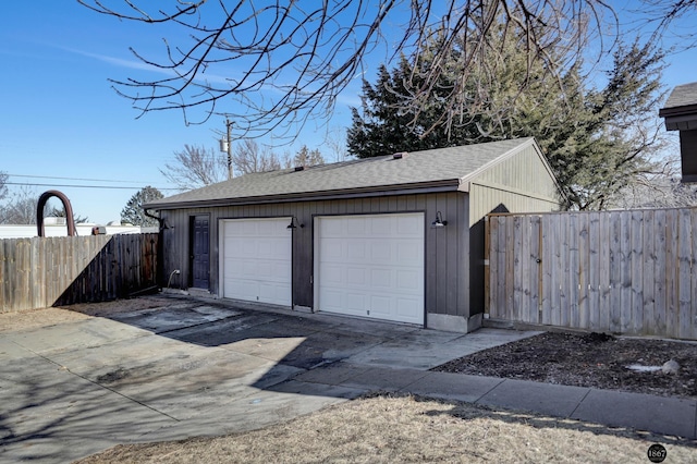 detached garage featuring fence