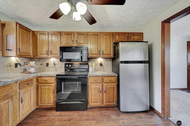 kitchen with black appliances, dark wood-style flooring, light countertops, and decorative backsplash