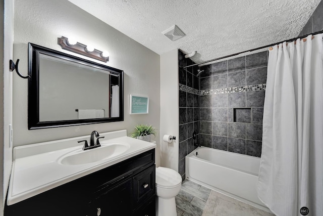 full bathroom with visible vents, toilet, shower / bath combo with shower curtain, a textured ceiling, and vanity