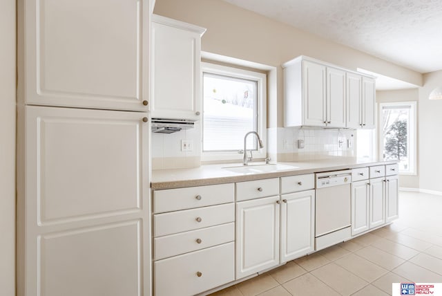 kitchen with sink, white cabinets, decorative backsplash, and dishwasher