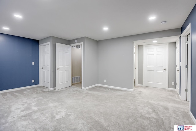 basement featuring light carpet