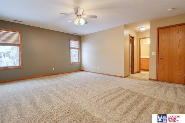 unfurnished room featuring ceiling fan and light carpet