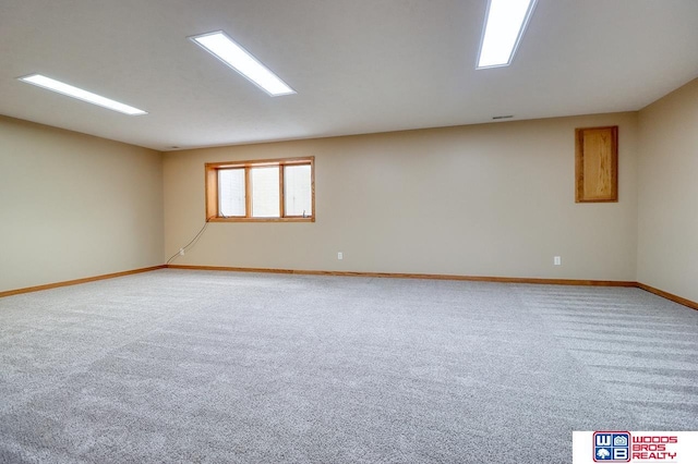 carpeted empty room with vaulted ceiling