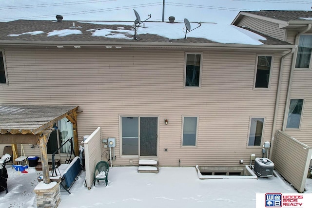 snow covered property featuring cooling unit