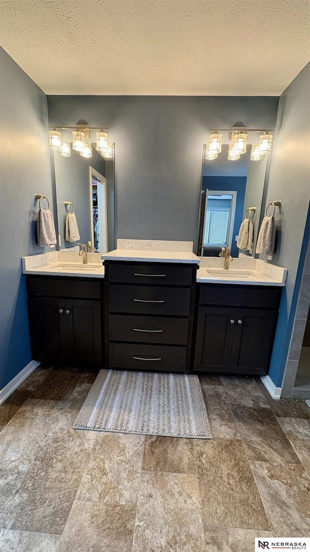 bathroom with vanity and a textured ceiling