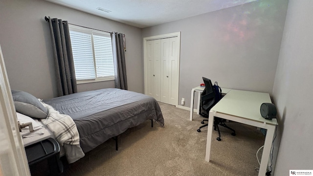 carpeted bedroom with a closet