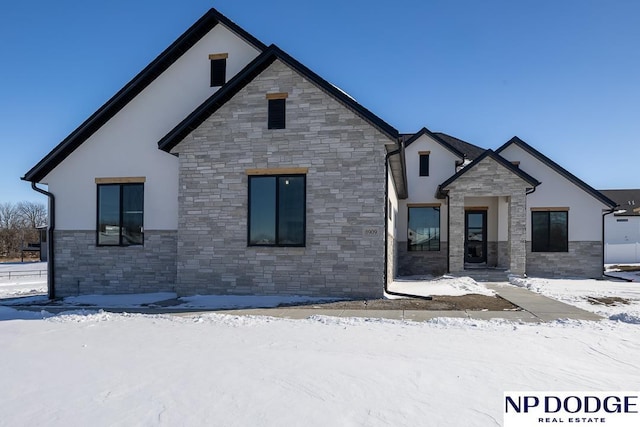 view of front of home with stone siding and stucco siding