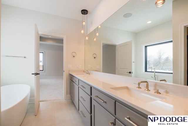 8909 Appaloosa Ln, Lincoln, NE 68520 - bathroom featuring double vanity, a freestanding tub, tile patterned flooring, and a sink