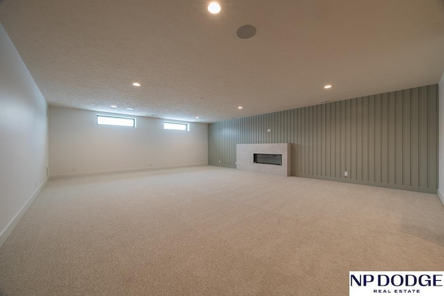 8909 Appaloosa Ln, Lincoln, NE 68520 - basement with a tiled fireplace, baseboards, carpet, and recessed lighting