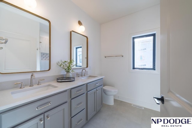 8909 Appaloosa Ln, Lincoln, NE 68520 - bathroom with double vanity, visible vents, tile patterned floors, and a sink