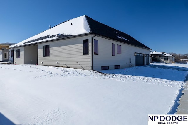 8909 Appaloosa Ln, Lincoln, NE 68520 - snow covered rear of property with a garage