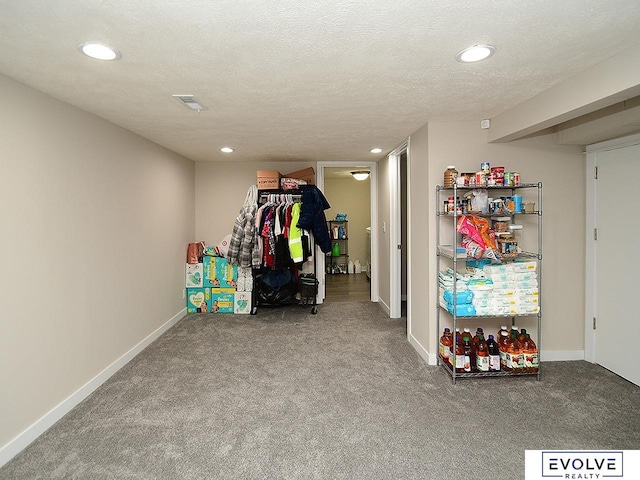 game room featuring carpet floors and a textured ceiling