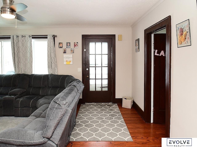 living room featuring ceiling fan, crown molding, dark hardwood / wood-style flooring, and a wealth of natural light