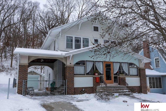 view of front of property featuring a garage and an outbuilding