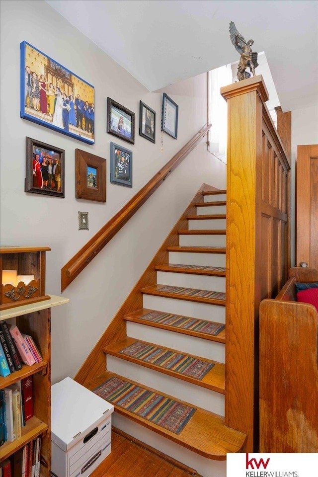 stairs featuring wood-type flooring