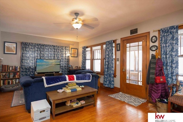 living room with hardwood / wood-style flooring and ceiling fan