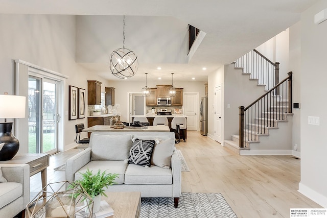 living room featuring light hardwood / wood-style floors and a chandelier