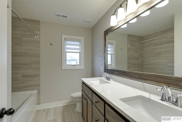 bathroom featuring toilet and vanity