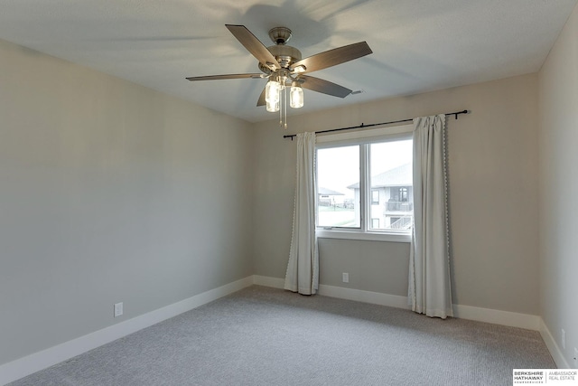 unfurnished room with ceiling fan and light colored carpet