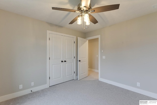 unfurnished bedroom featuring a closet, light colored carpet, and ceiling fan