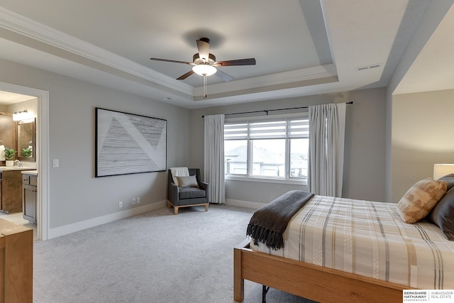 carpeted bedroom featuring ornamental molding, sink, a raised ceiling, and connected bathroom