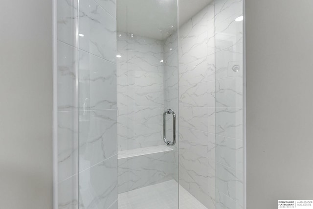 bathroom featuring a shower with shower door