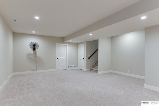 basement featuring light colored carpet