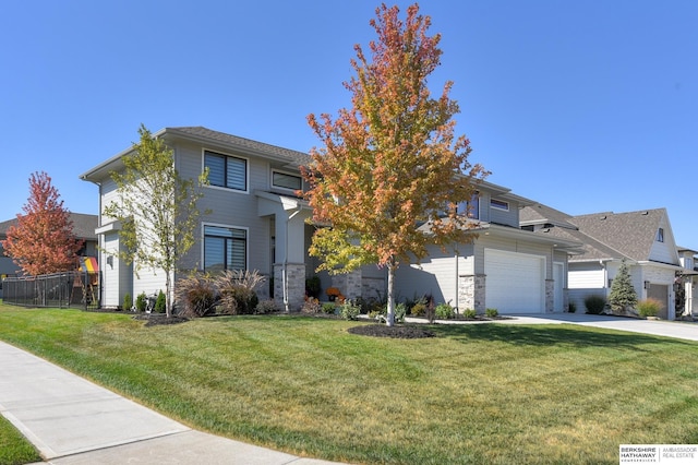 view of front facade with a garage and a front lawn