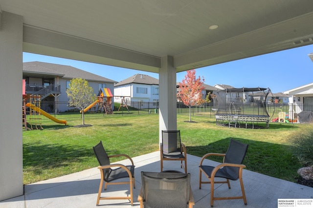 view of patio / terrace with a trampoline and a playground