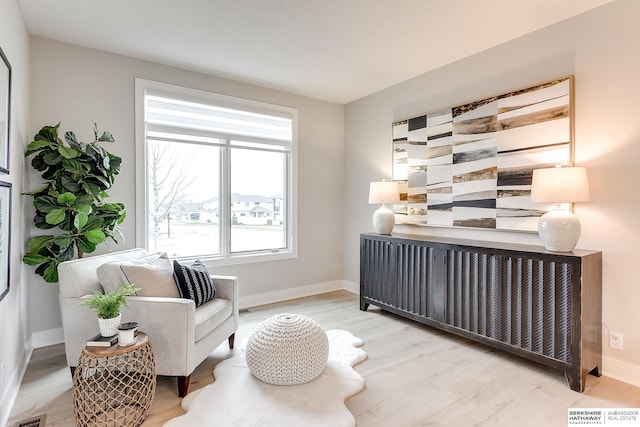 living area with light hardwood / wood-style flooring