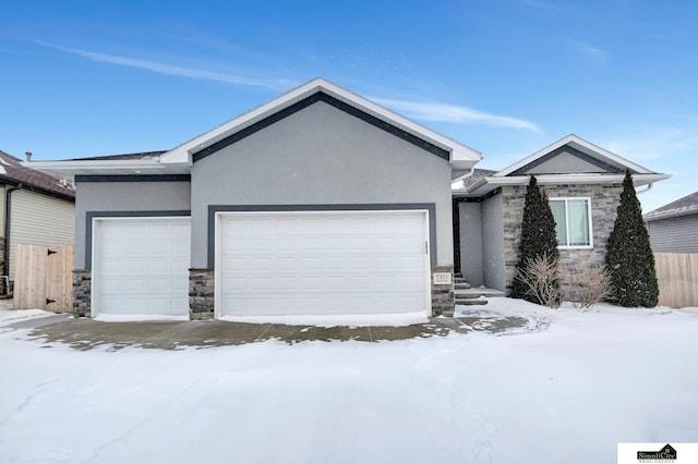 single story home featuring stone siding, an attached garage, and stucco siding