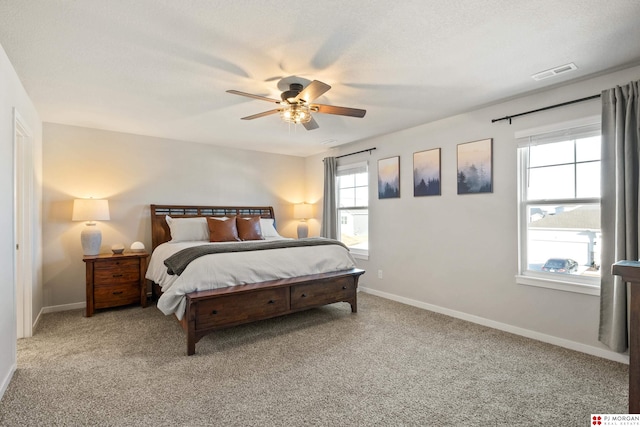 bedroom featuring ceiling fan, carpet flooring, and a textured ceiling