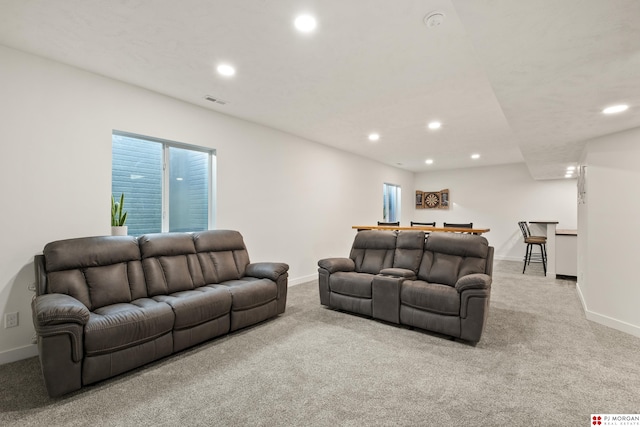 living room featuring light carpet and a healthy amount of sunlight