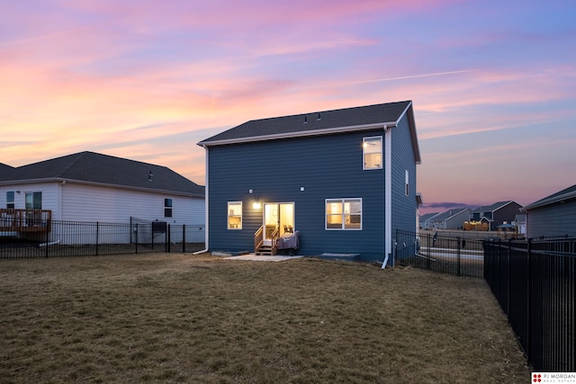 back house at dusk with a yard