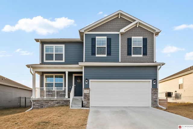 craftsman-style house featuring a front lawn, a porch, cooling unit, and a garage