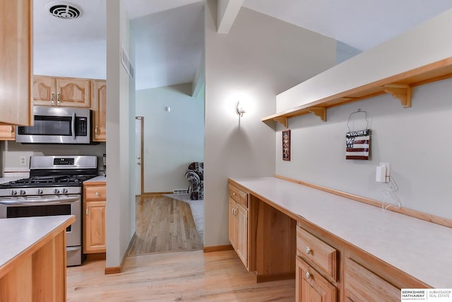 kitchen featuring light wood-type flooring, light brown cabinetry, and stainless steel appliances