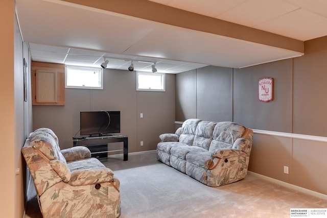 living room with a paneled ceiling and light colored carpet