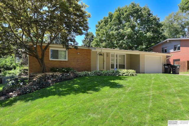 single story home featuring a front yard and a garage