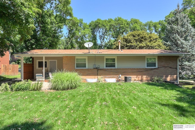 rear view of property with a lawn