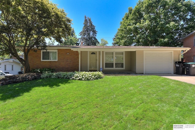 ranch-style house featuring a front lawn and a garage