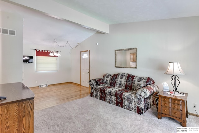 carpeted living room with lofted ceiling with beams